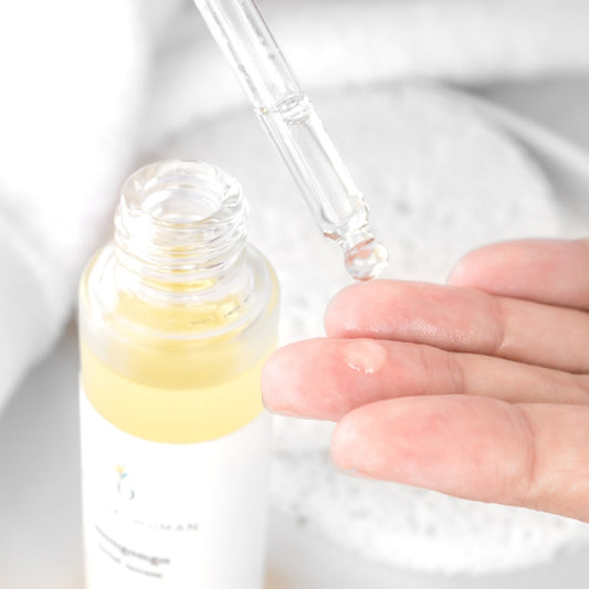 Original Human Co. Facial Serums The Benefits of Face Massage and How To Do It - close up image of Original Human Co Facial Serum bottle and hand